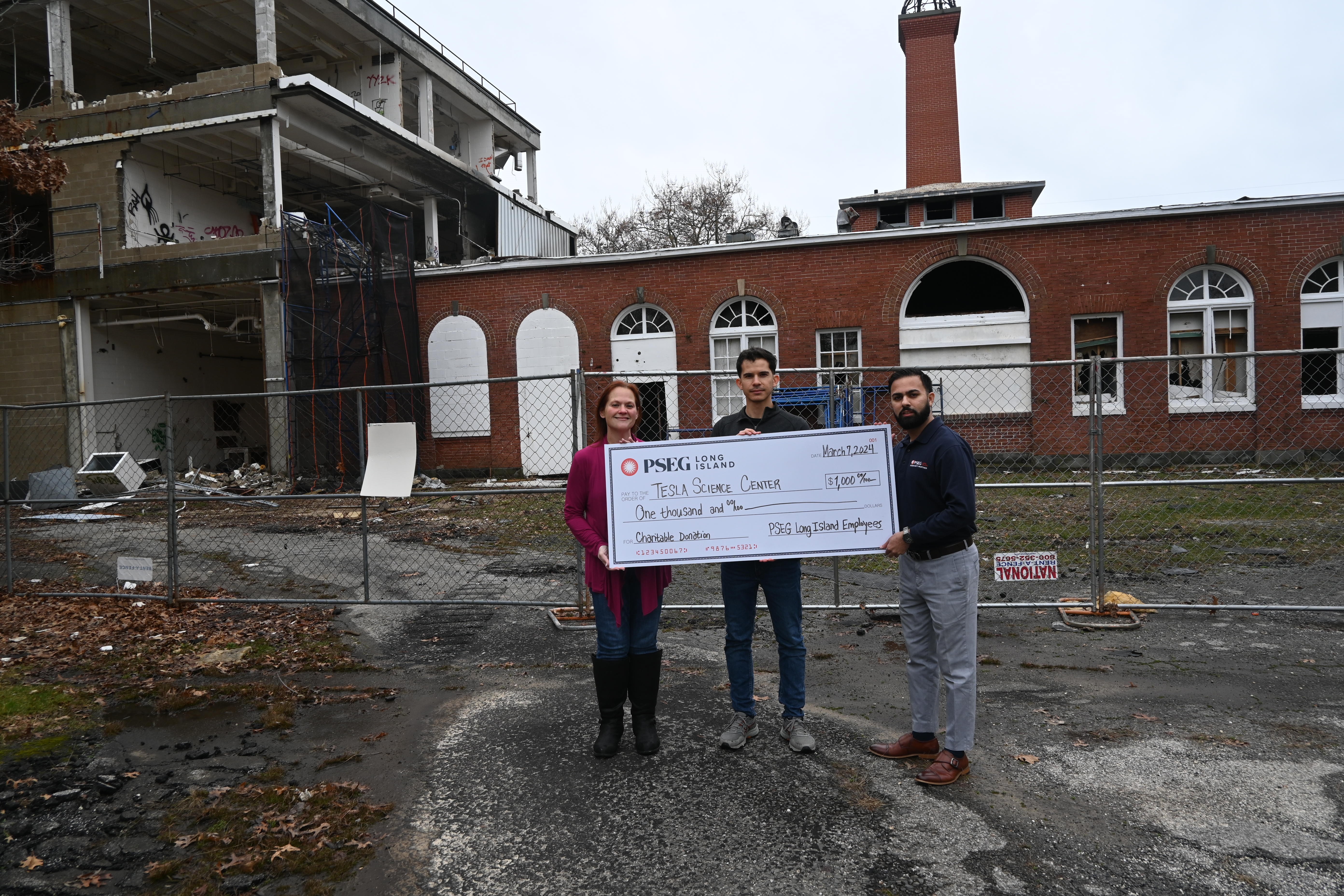 Earlier this year PSEG Long Island employees donated $1,000 to the Tesla Museum to help rebuild after a devastating fire last year. The grant was made possible by PSEG Long Island’s employee business resource group (EBRG), GREEN, which advocates for clean energy alternatives. Pictured are (l-r): Danielle Butler and Douglas Borge of the Tesla Museum and Saqib Madni of PSEG Long Island.