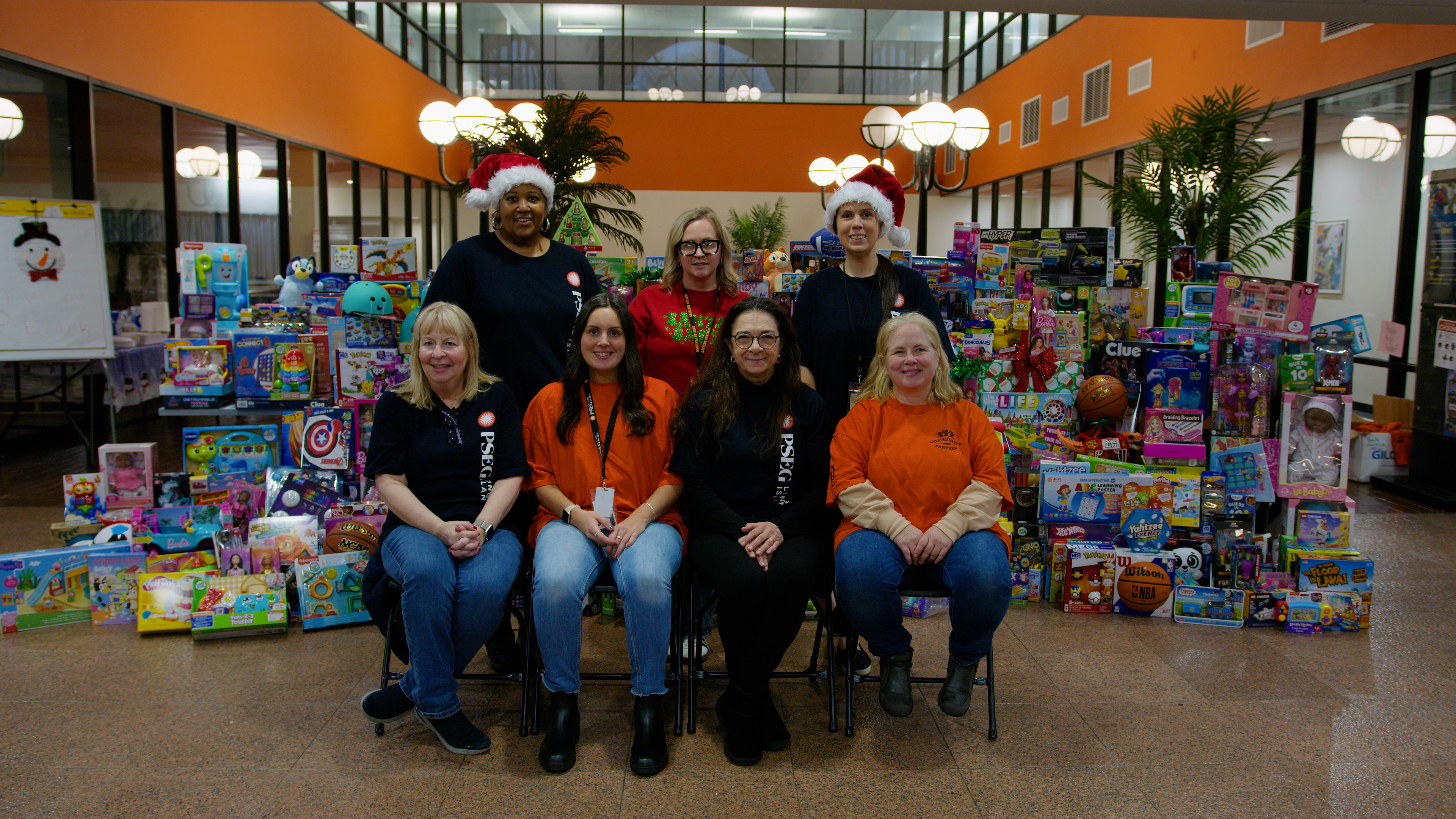 Pictured with some of the 500 gifts donated and collected by PSEG Long Island employees to be distributed to organizations and given out to local children are: (front row) Susan Desch, Brianna Maye, Mirela Filipovic and Patricia Cuilla;(back row) Tonya Simmons, Tara Bodenmiller, and Kerrie Dutton. All are PSEG Long Island employee volunteers. 