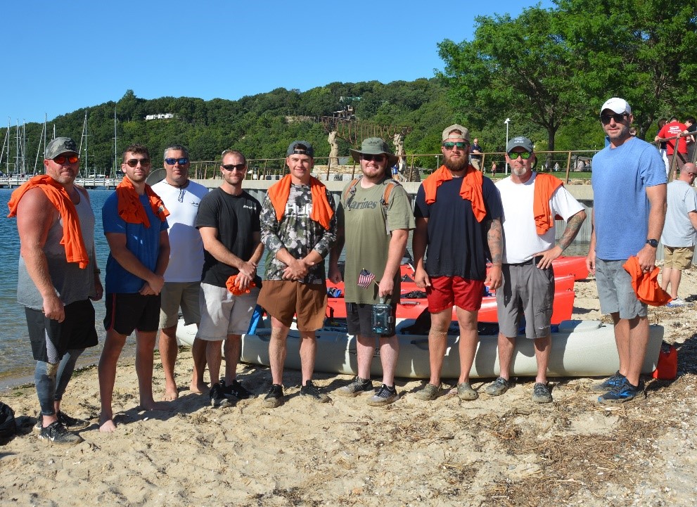 (l-r) PSEG Long Island employee-military veterans Thomas Leuschner, Evan Rohman, Richard Rohman, Matthew Testagrose, Michael Probst, Devin McLaughlin, Michael Pira, Leo Tolson and Thomas Sketch after a 22-mile kayaking trip to increase awareness about PTSD and veteran suicide.